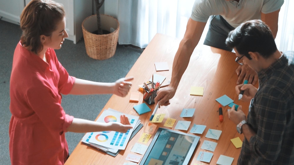 logo-design Team planning content with sticky notes on a table